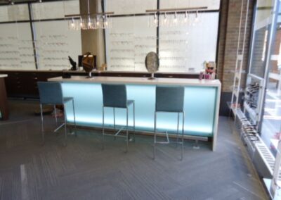 Plastic laminate desk with glass accents for Metro Eye.